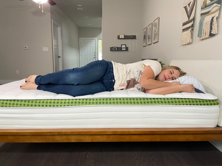 A woman sleeps on her side on the Brunswick mattress