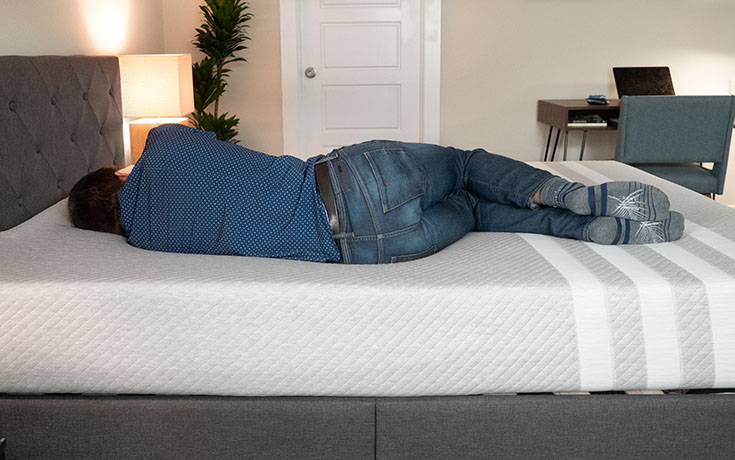 man sleeping on his side on a Leesa mattress