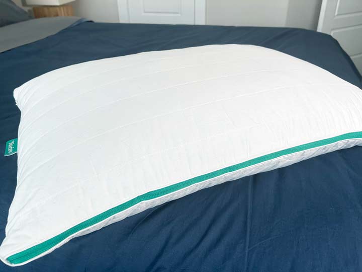 A picture of the Marlow pillow on a bed, showcasing its cotton cover.