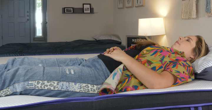 A woman sleeps on the Nectar Premier Hybrid mattress